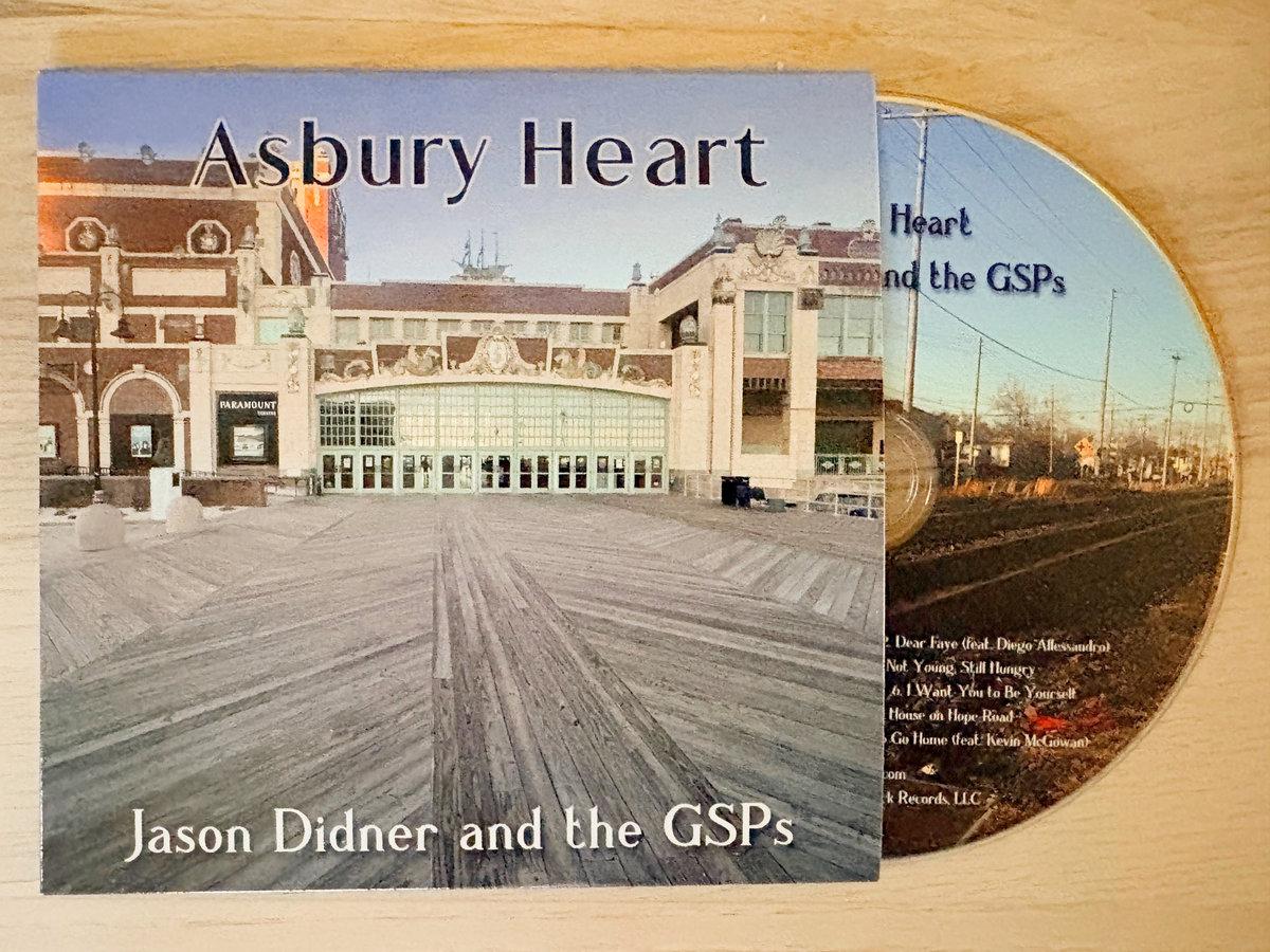 CD jacket for "Asbury Heart" by Jason Didner and the GSPs, resting against the disc, featuring a photo of Asbury Park's Convention Hall and boardwalk.